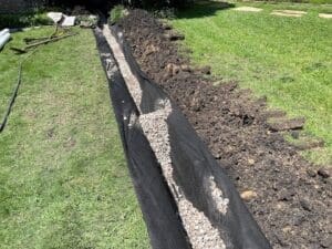 installing-a-french-drain installing a french drain to remove water from building and standing water on the landscape