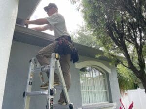 Jackson, the owner of Castillo's Gutter & Aluminum installing new seamless gutters