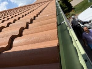 &-inch K-style Aluminum gutters - customer chose green to accent the contrast between the orange Spanish tiles.   